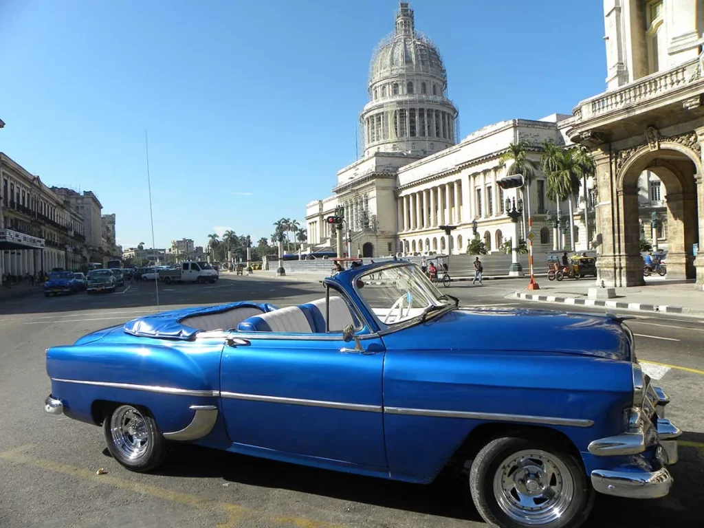 convertible car in front of havana capitol