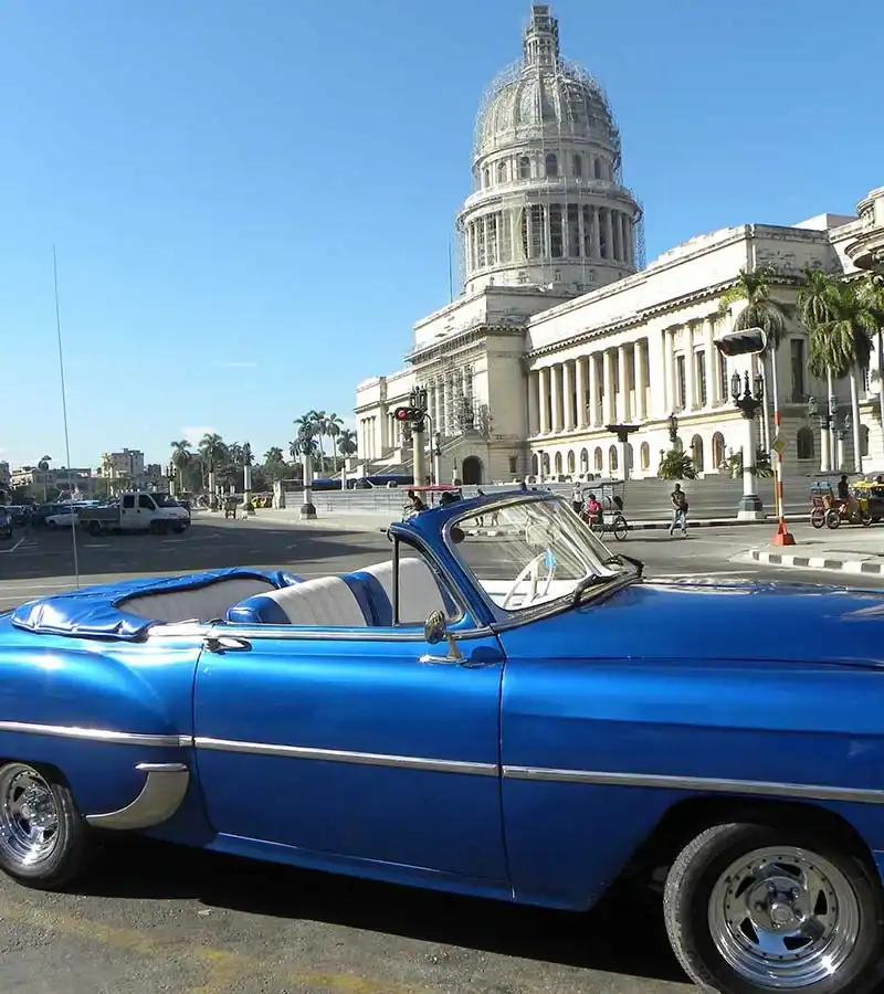 convertible car in front of havana capitol